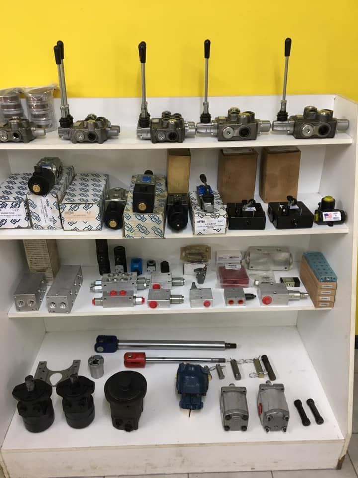 Display of assorted walkie-talkies and radios on white shelves against a yellow wall