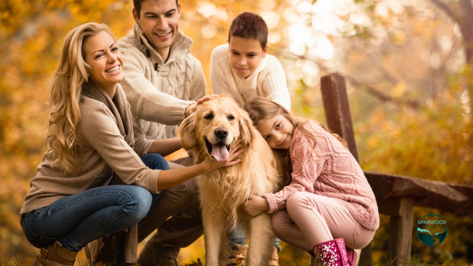 A family is petting a dog in a park.