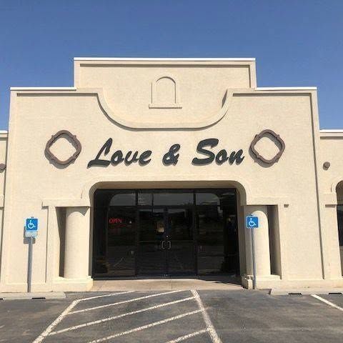 Love & Son storefront with beige facade and accessible parking spaces in front
