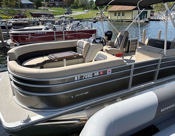 2023 Trophy T24CX with blue hull tied up at dock