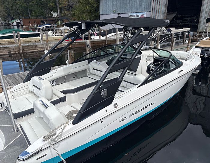 2023 Trophy T24CX with blue hull tied up at dock