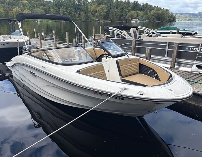 2023 Trophy T24CX with blue hull tied up at dock