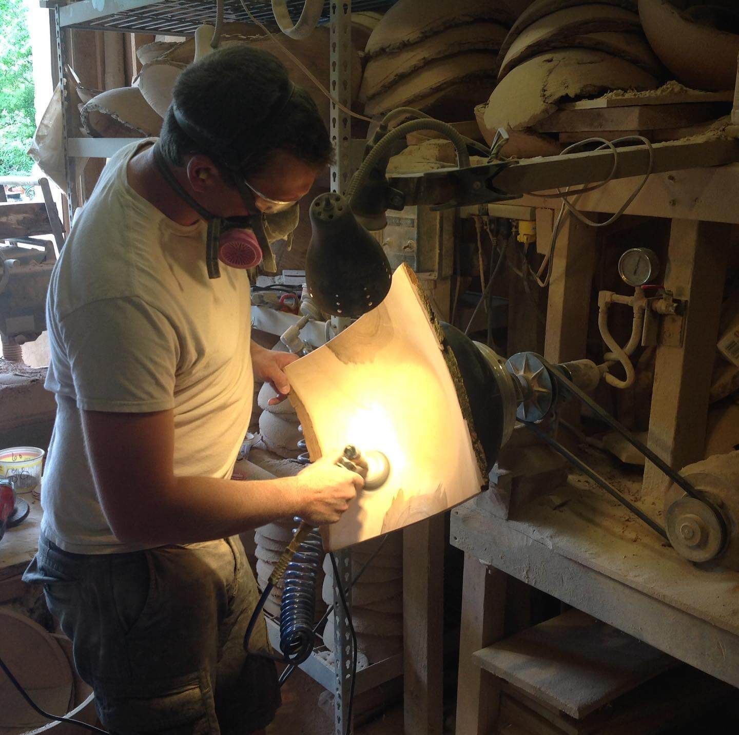 Curtis Matthews hand carving wood in studio