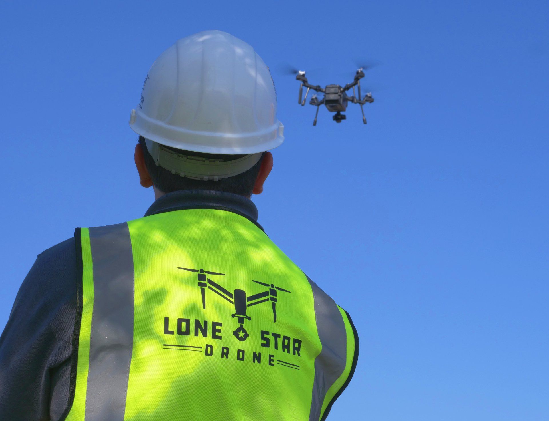 lone star drone at work with operator near
