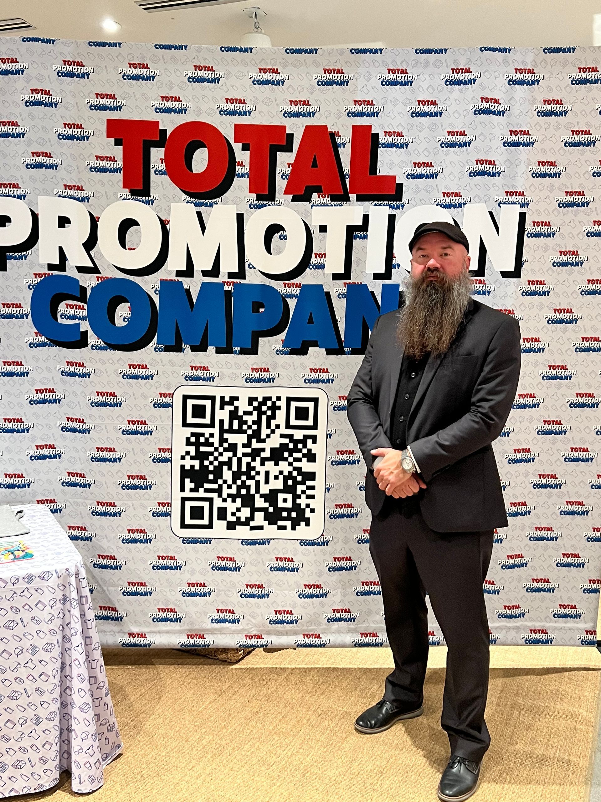 brandon in front of company logo