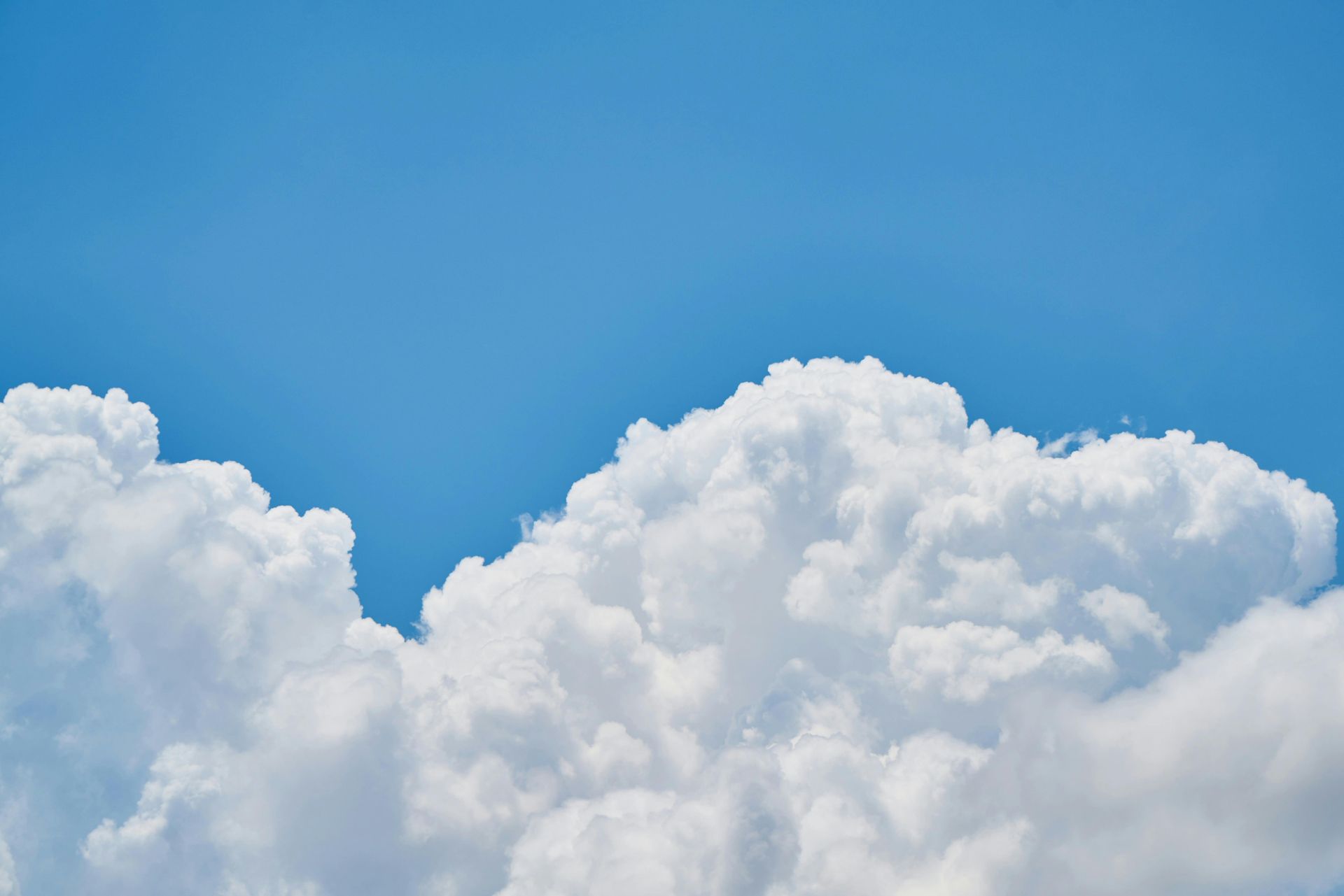 Blue sky with fluffy white clouds.