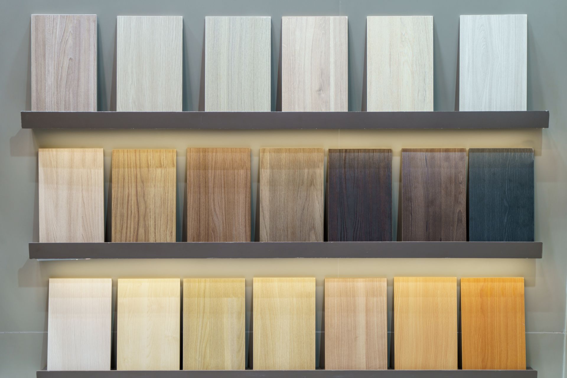 Wood flooring samples in various colors displayed on shelves.
