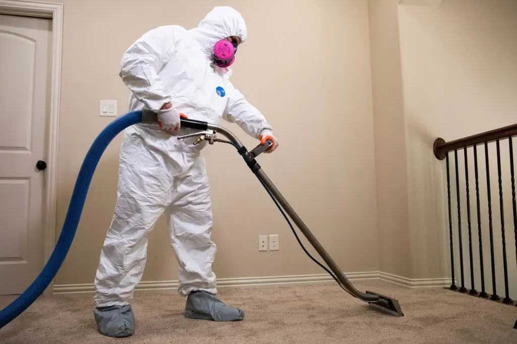 man testing mositure level on bathroom wall