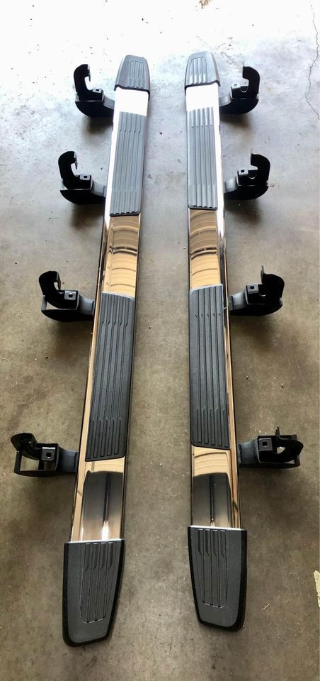 A pair of side steps are sitting on top of a concrete floor.