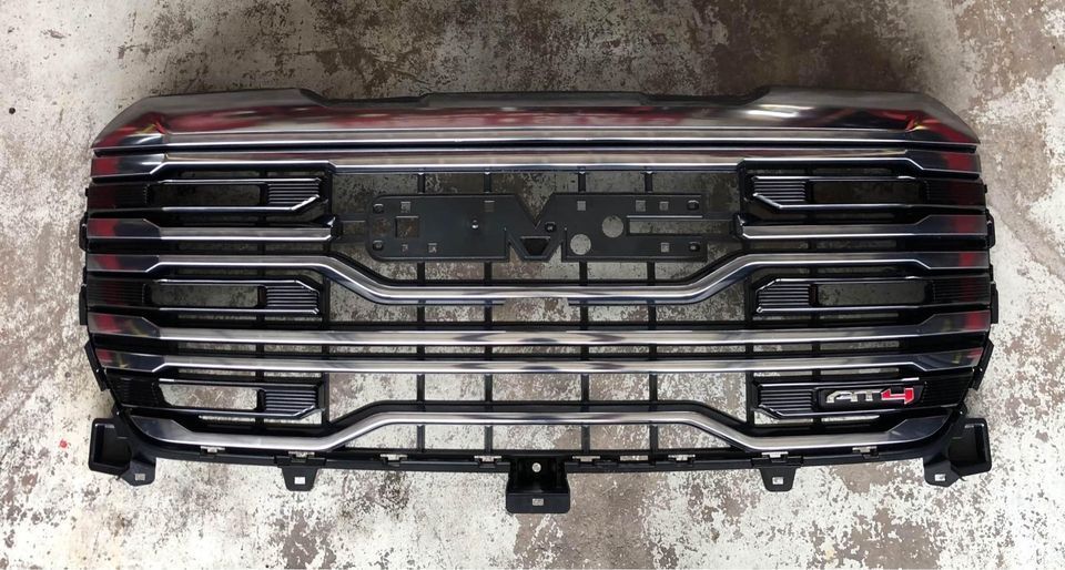 A black grille is sitting on a concrete surface