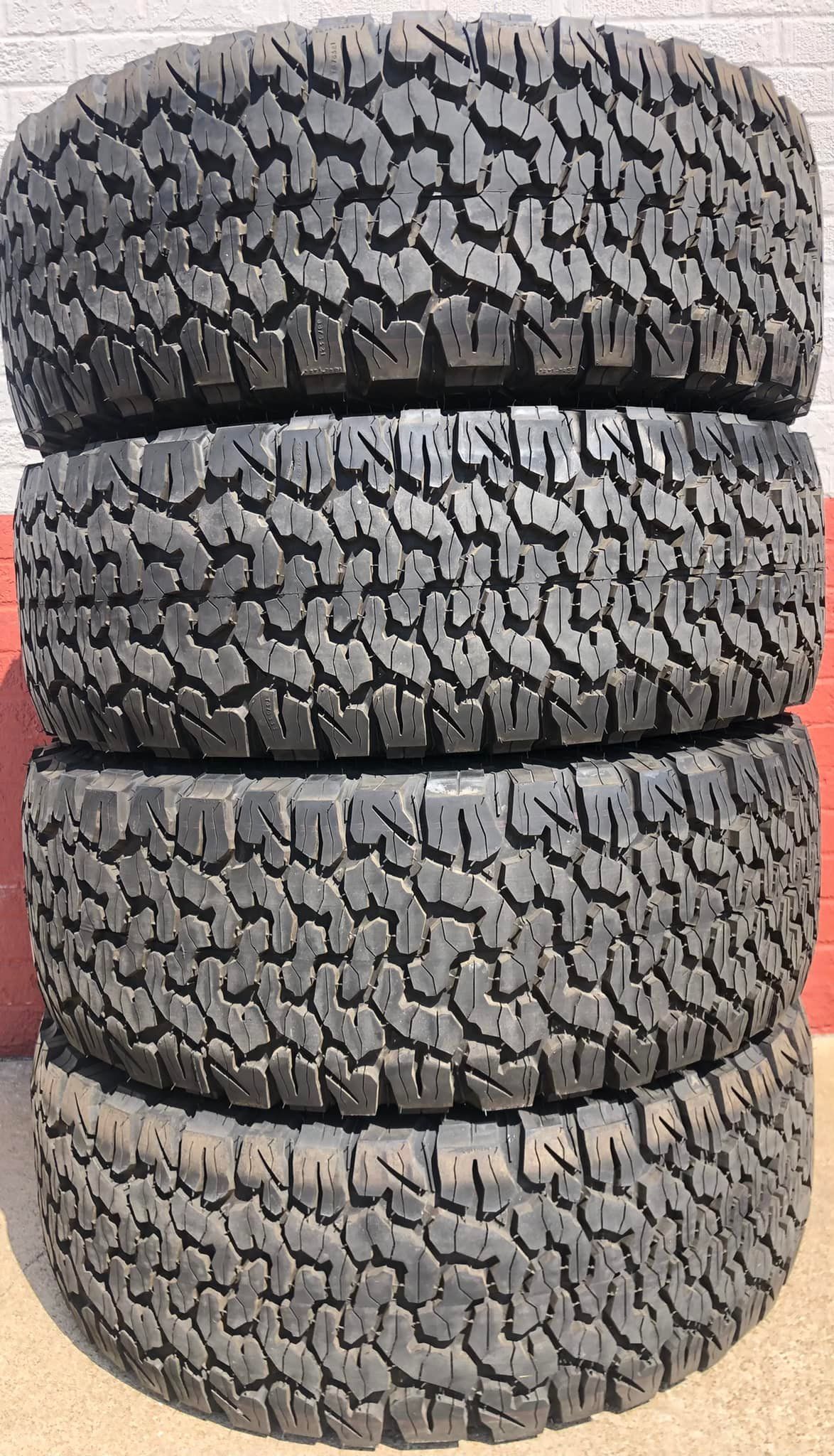 Four tires are stacked on top of each other on a table.