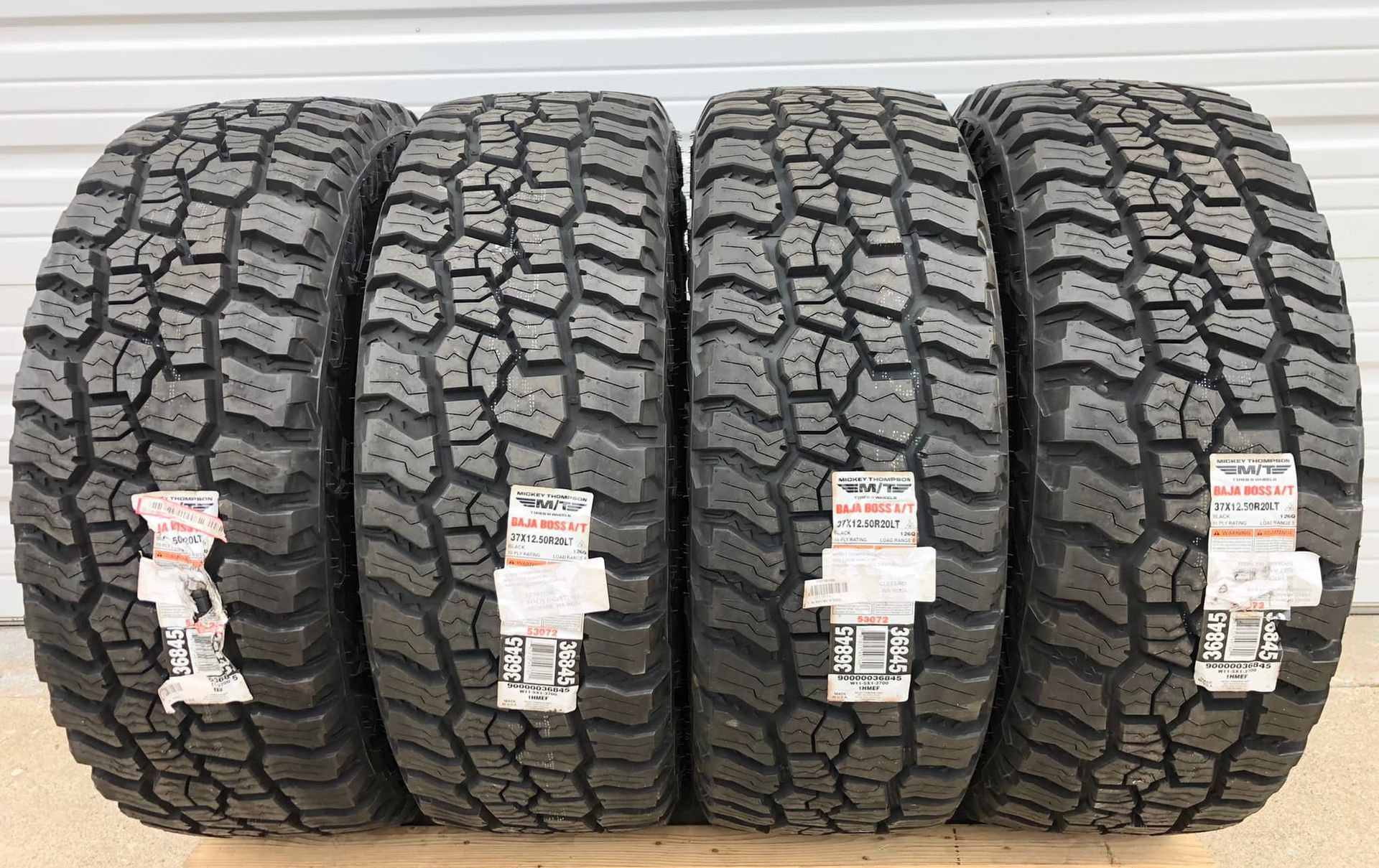Four tires are stacked on top of each other on a table.