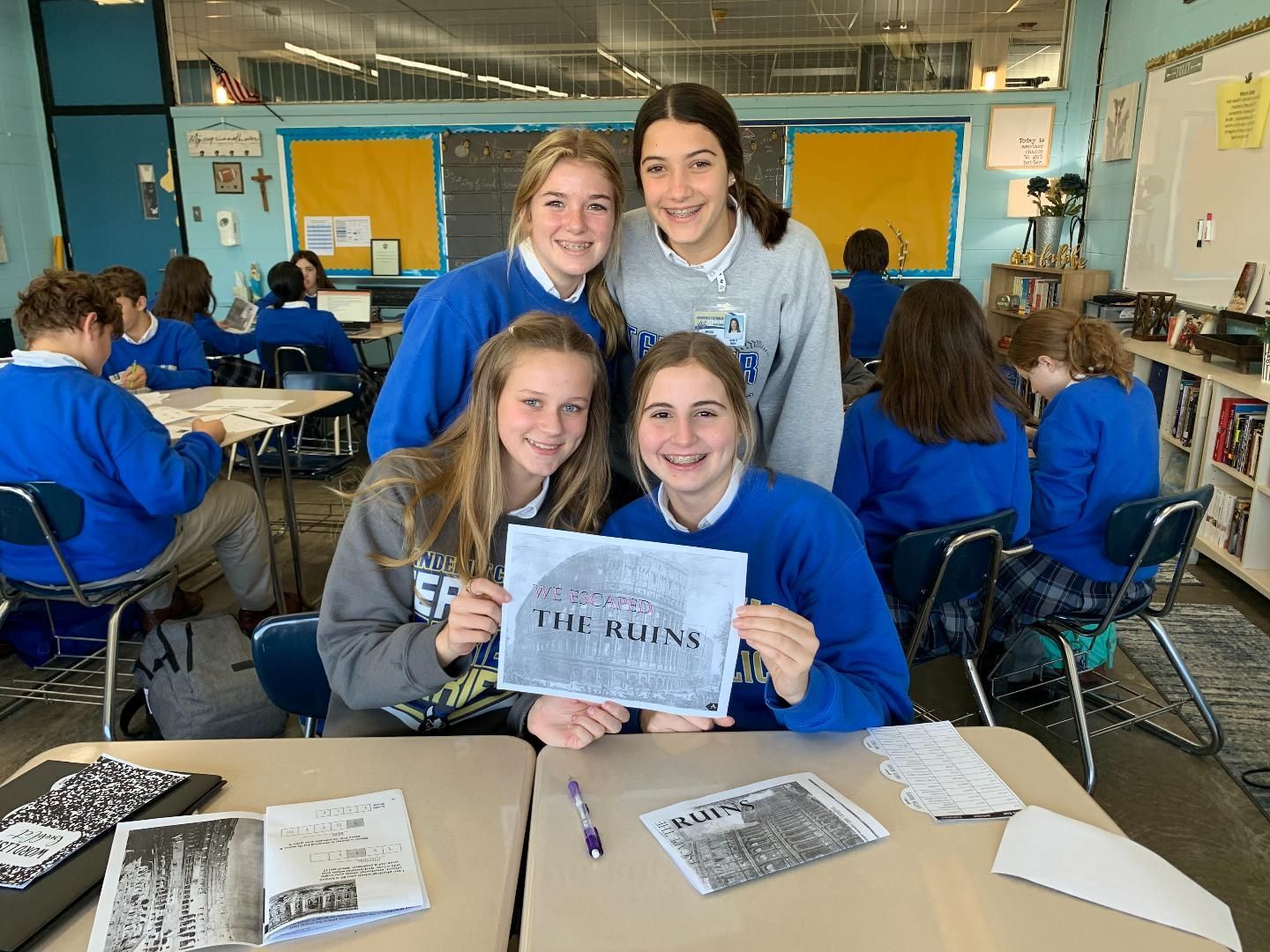 A group of young girls are posing for a picture in a classroom.