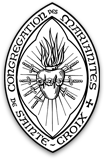 A black and white image of a seal with a heart in the center surrounded by rays of light.