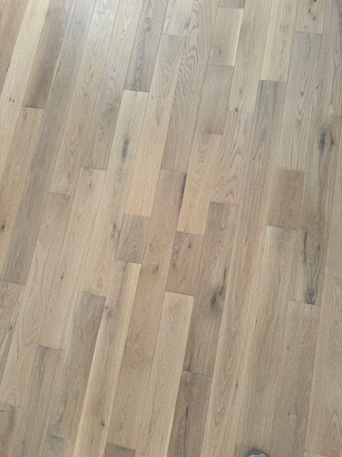 Light wood plank flooring with subtle grain and knots