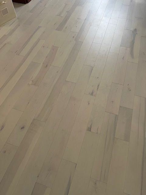 Light-colored wooden floor planks in a bright room