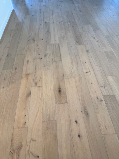 Light oak hardwood floor in a bright empty room