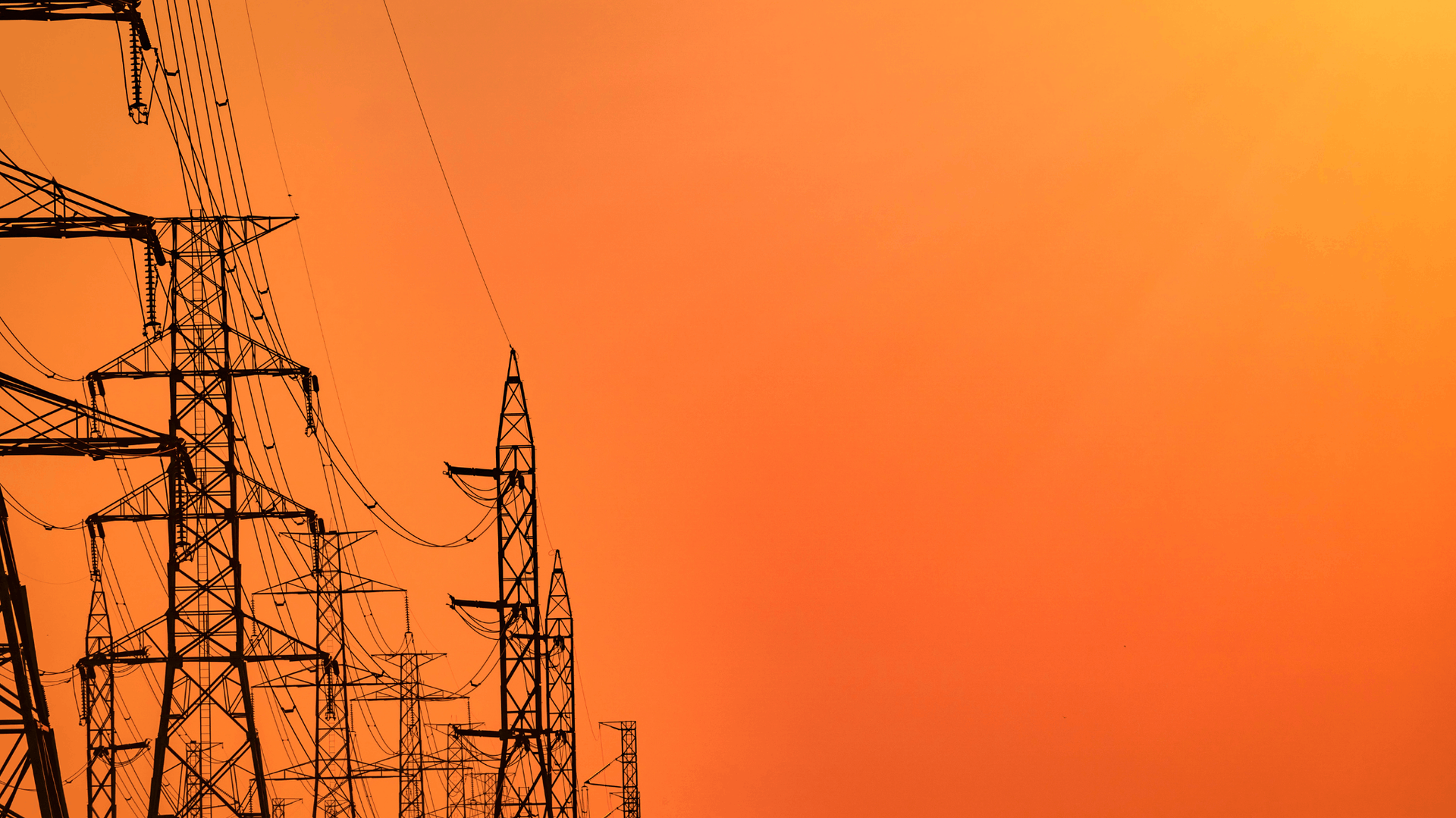 Silhouette of power lines against an orange sunset sky — Brian Williams Electrical Air Solar in Cooroibah, QLD