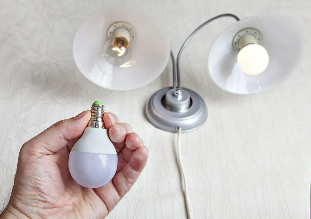 Hand Holding Led Lightbulb — Brian Williams Electrical Air Solar in Cooroibah, QLD