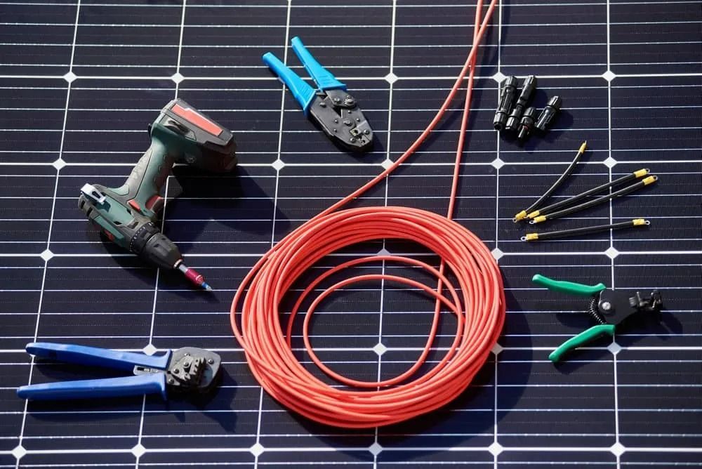Tools Including Wire and Drill on a Solar Panel — Brian Williams Electrical Air Solar in Cooroibah, QLD