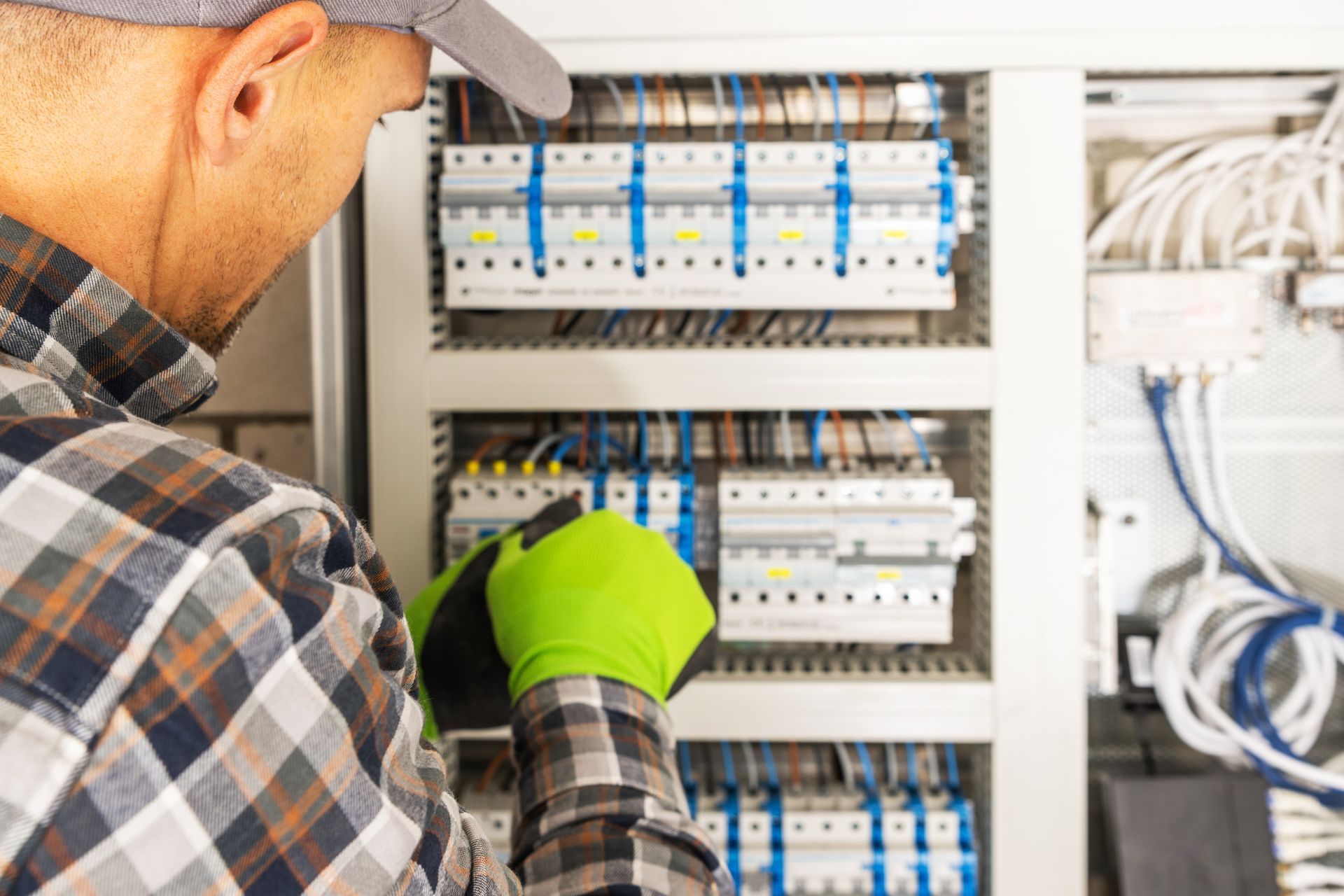 Electrician working on a circuit breaker panel — Brian Williams Electrical Air Solar in Cooroibah, QLD