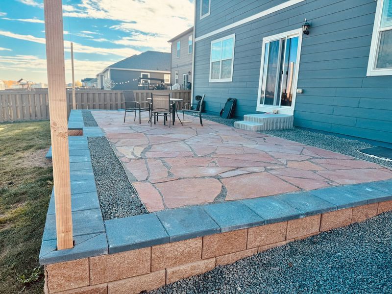 Gravel garden path with stepping stones, trees, and landscaped beds under a bright sky
