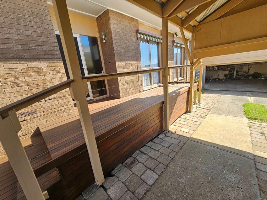 A Wooden Deck with a Brick Building in the Background — Painters Geelong in Geelong, VIC