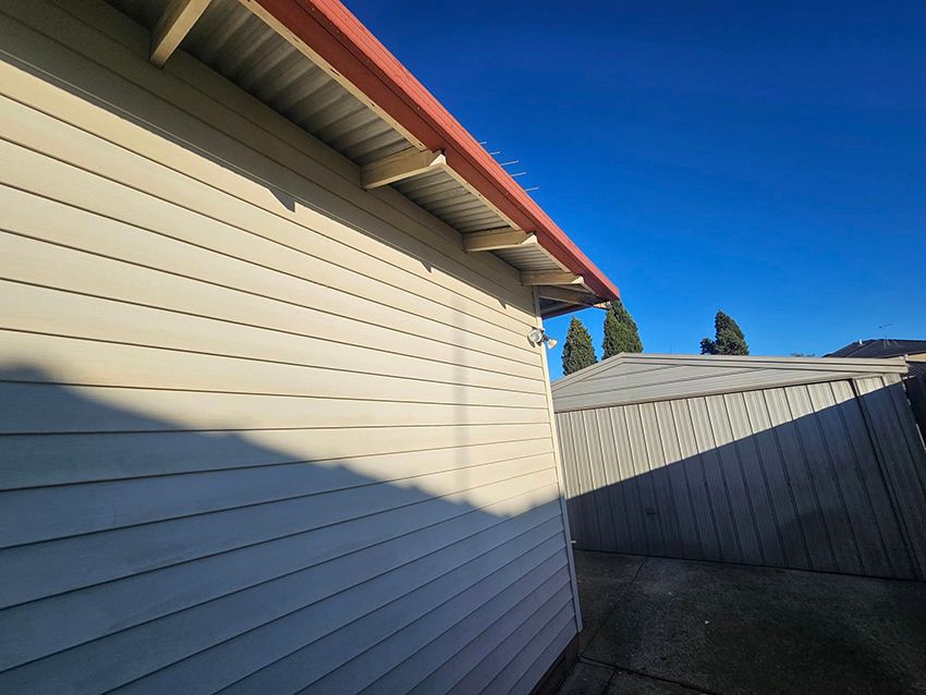 A White House with a Red Roof and a Fence in the Background — Painters Geelong in Geelong, VIC