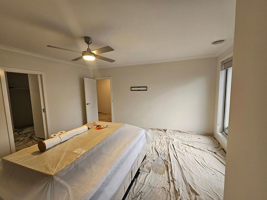 A Bedroom with a Bed and a Ceiling Fan — Painters Geelong in Geelong, VIC