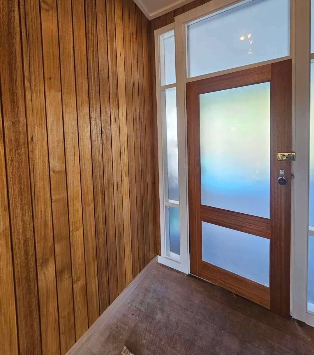 An Empty Room with Hardwood Floors and a Large Window — Painters Geelong in Geelong, VIC