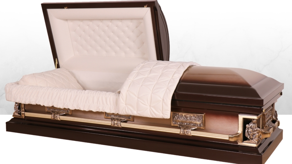 Open casket with white satin lining and dark wood exterior on a gold-trimmed base