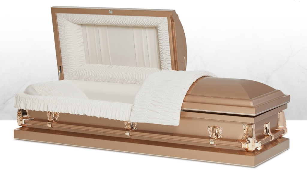 Open white and bronze casket with white interior and folded white drape