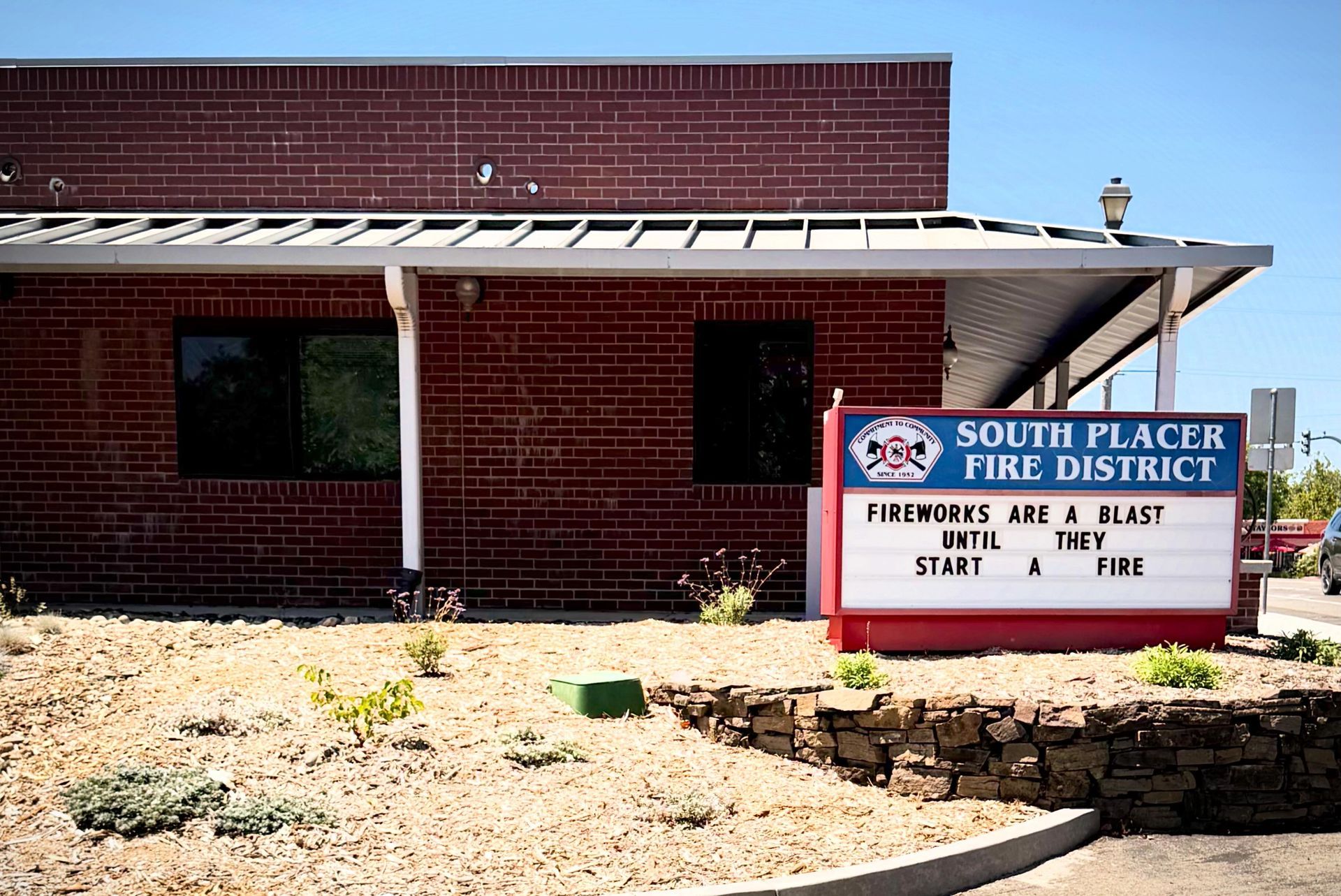 South Placer Fire District sign outside a red brick building with a white awning.