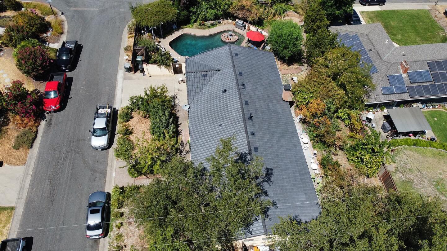 An aerial view of a house with a pool in the backyard.