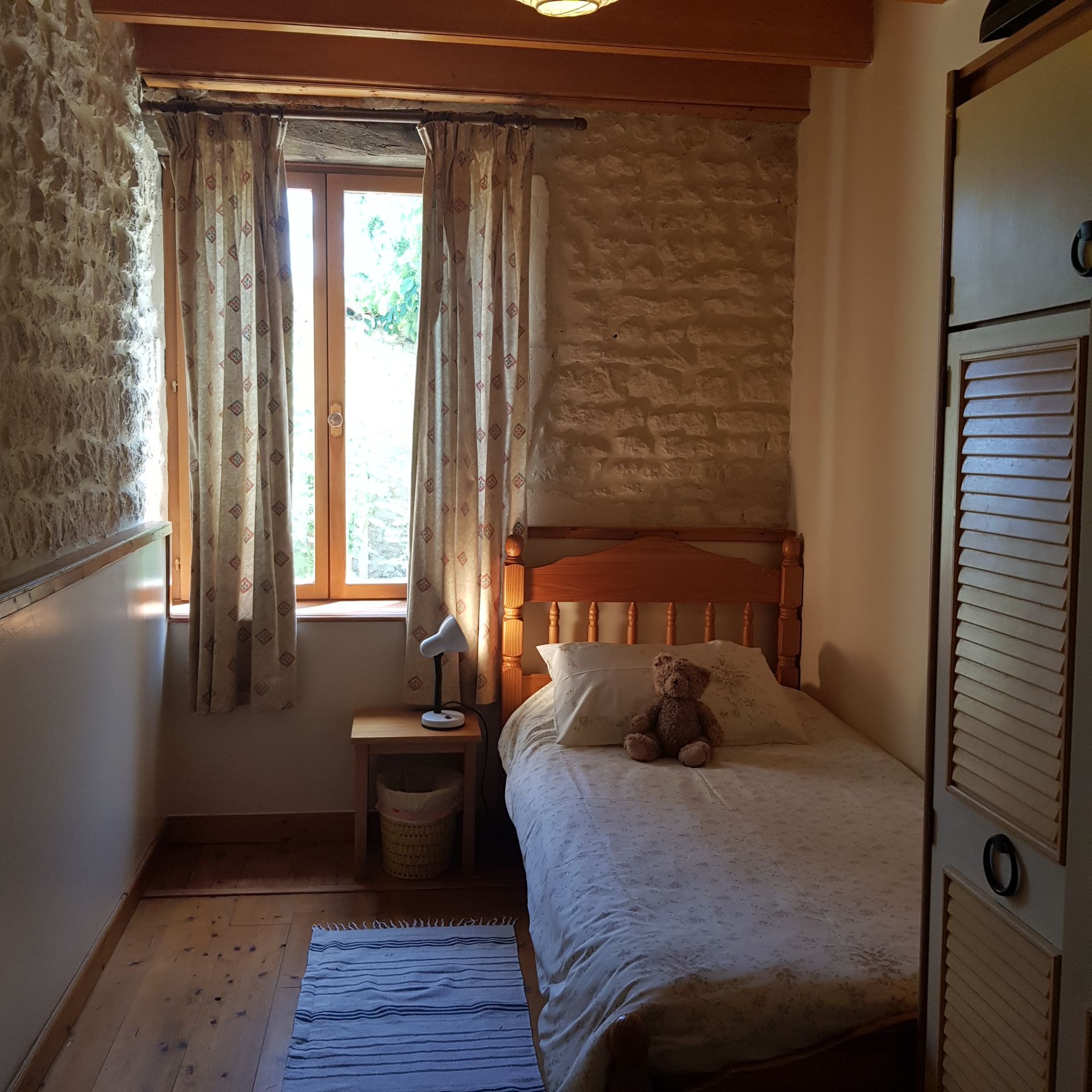 single bedroom with exposed stone walls