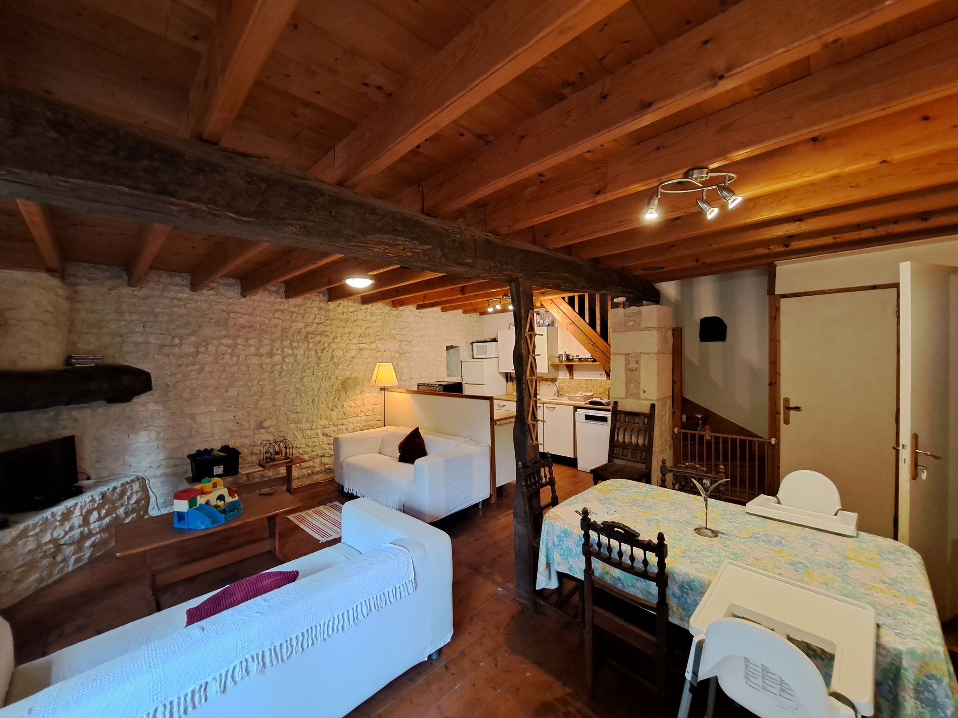 open plan sitting, dining, kitchen in a French gite