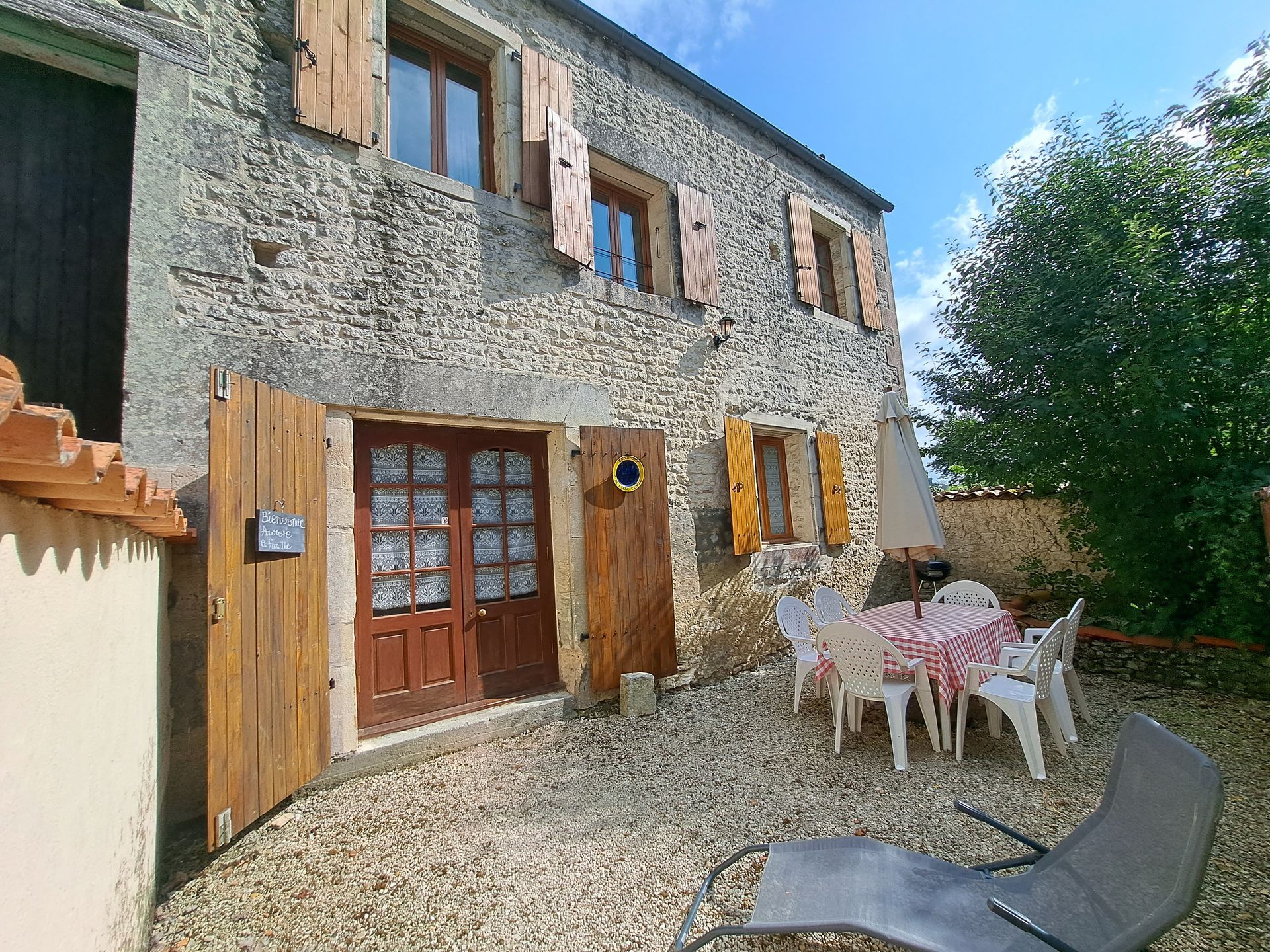 stone holiday cottage in France with wooden shutters
