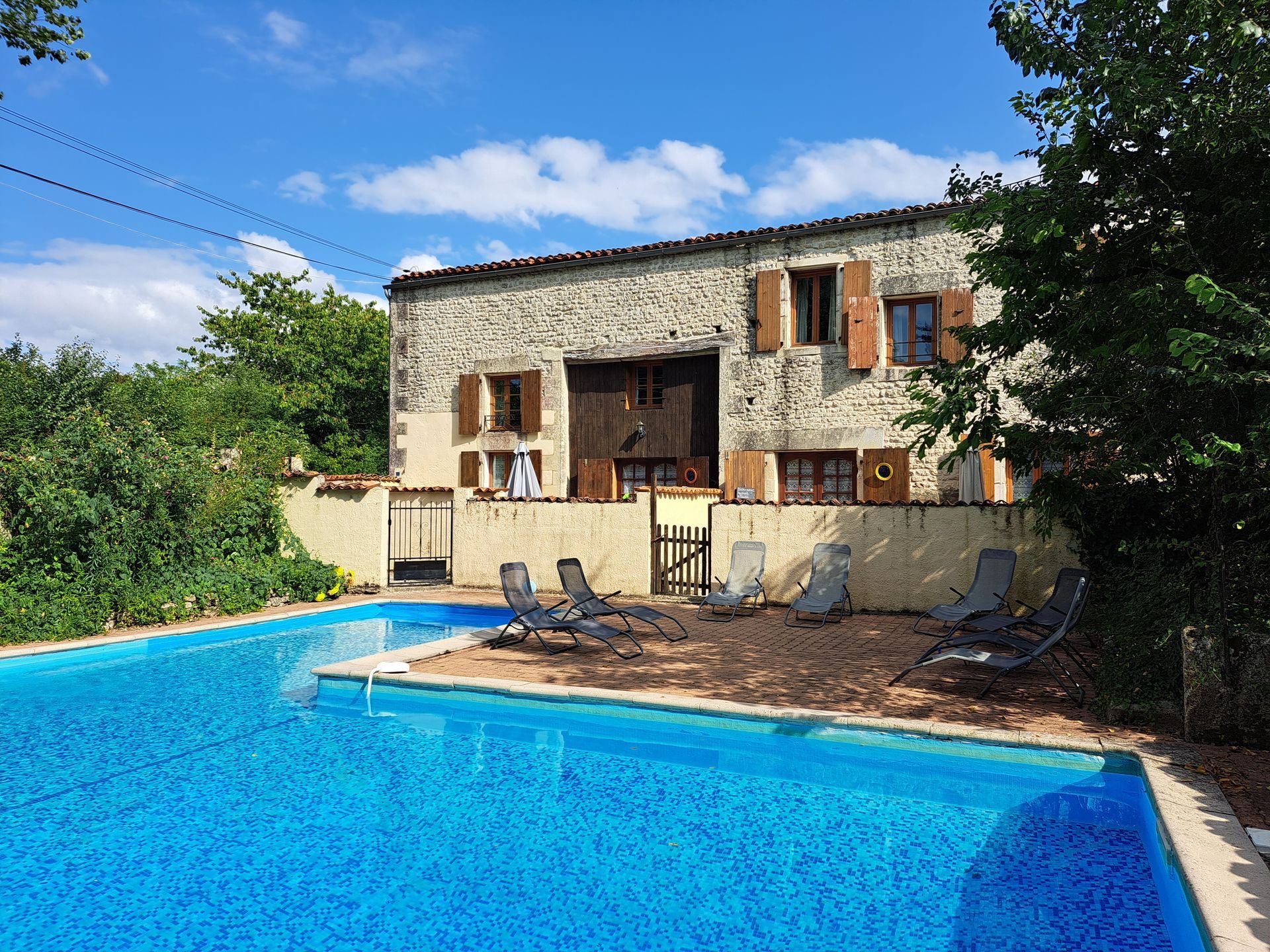 View of French gites with swimming pool in the foreground