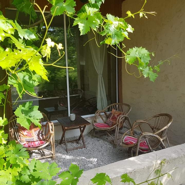 shaded terrace area with wicker chairs
