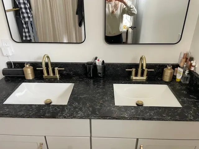 A bathroom with two sinks and two mirrors.