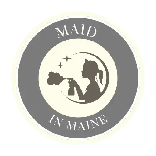 A maid in maine logo with a silhouette of a woman holding a spray bottle.