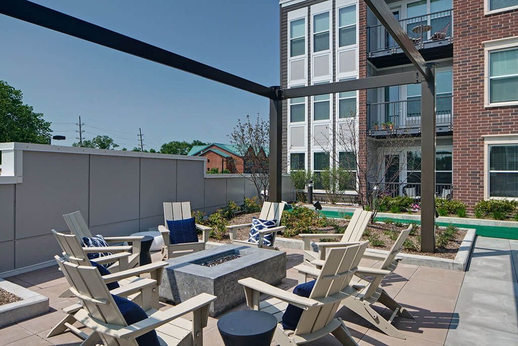 adirondack chairs surrounding an outdoor firepit 