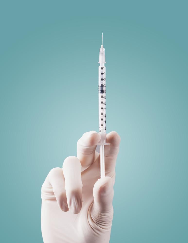 a Hand in a Glove is Holding a Syringe — Warners Bay Pharmacy In Warners Bay, NSW