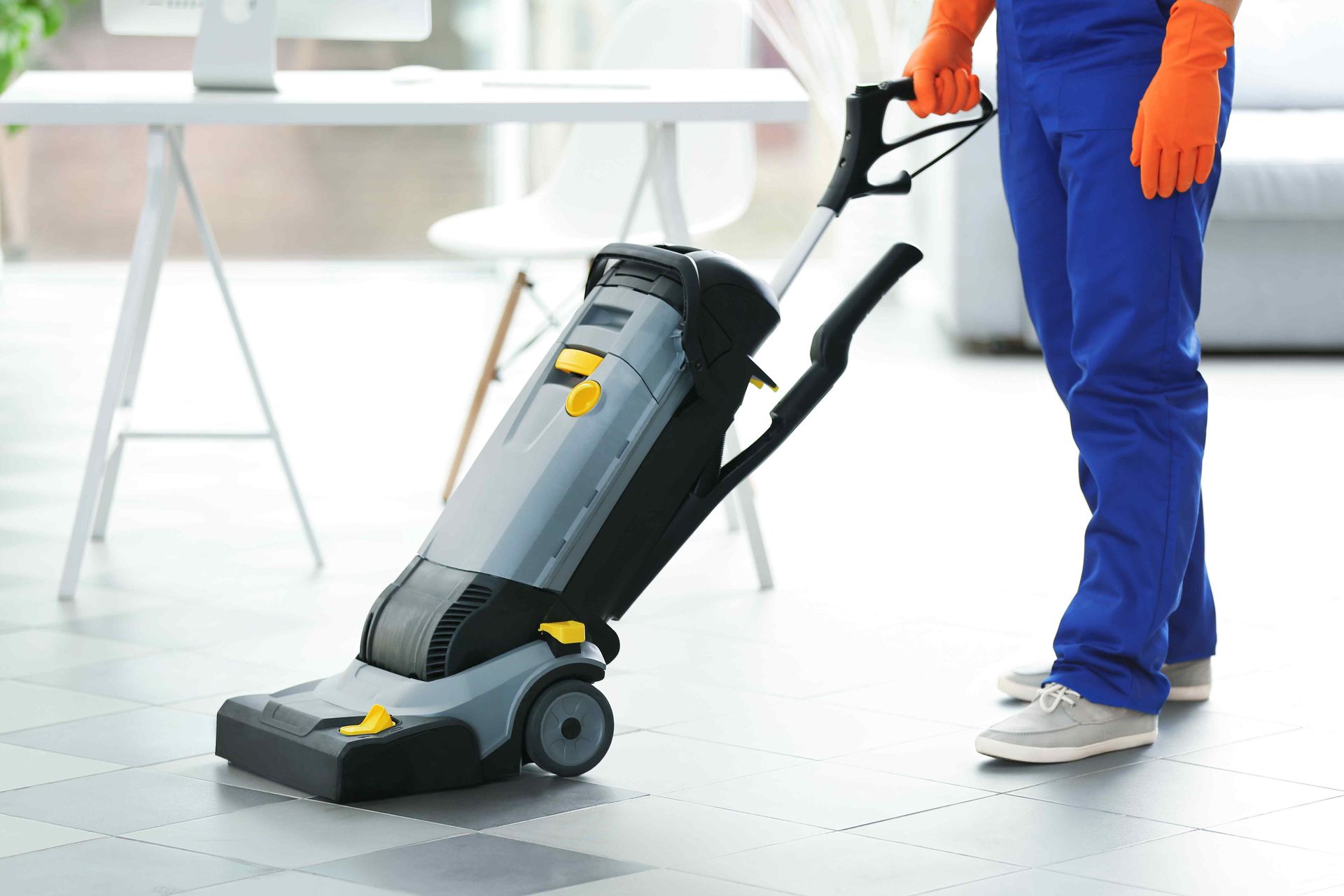 An employee cleaning a commercial tile floor