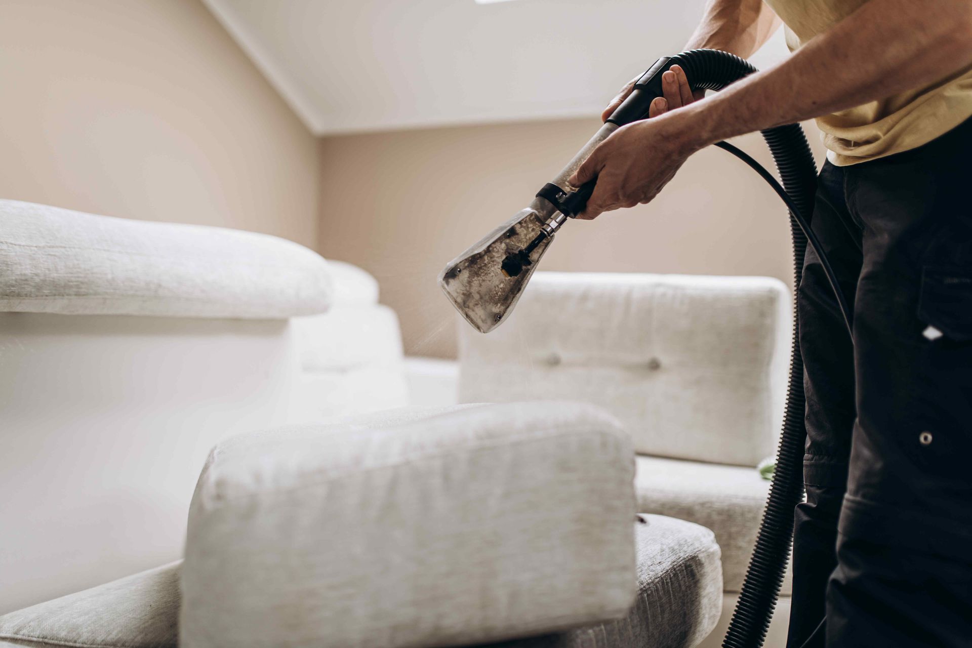 Applying a detergent solution to upholstery