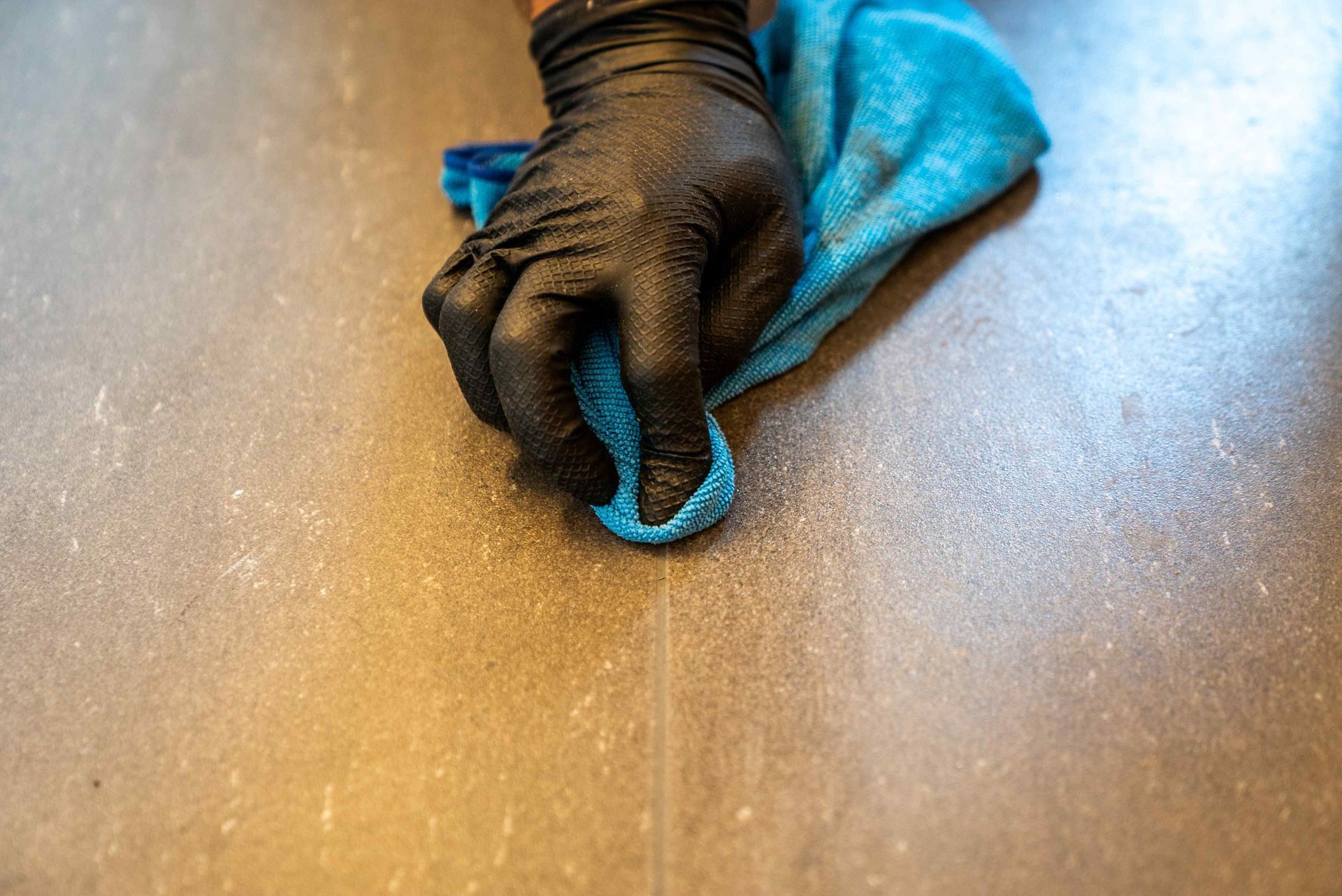 Wiping a grout line clean