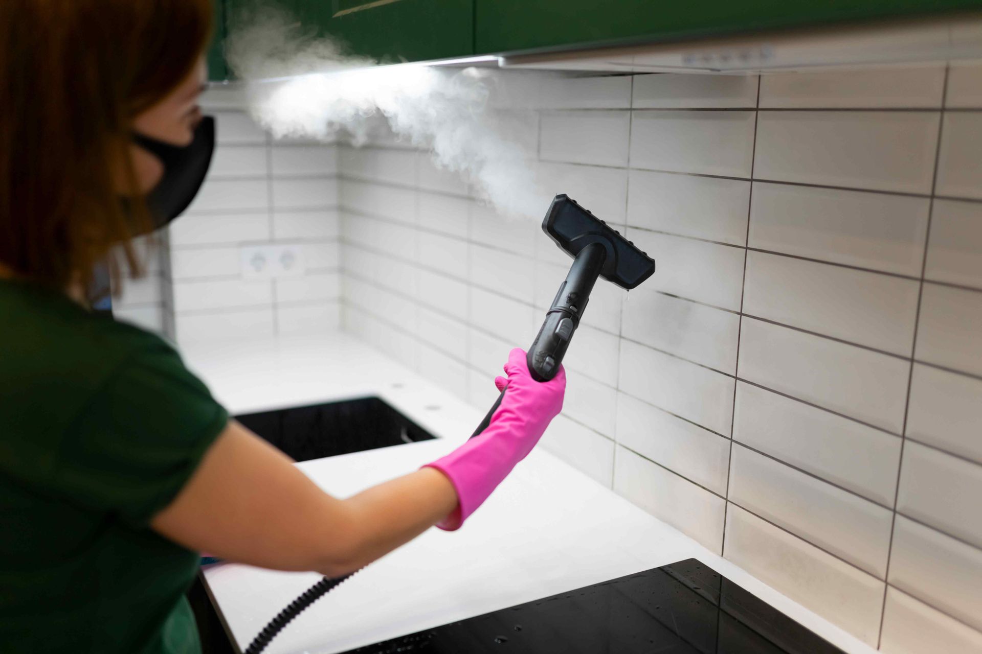 Steam cleaning a tiled wall