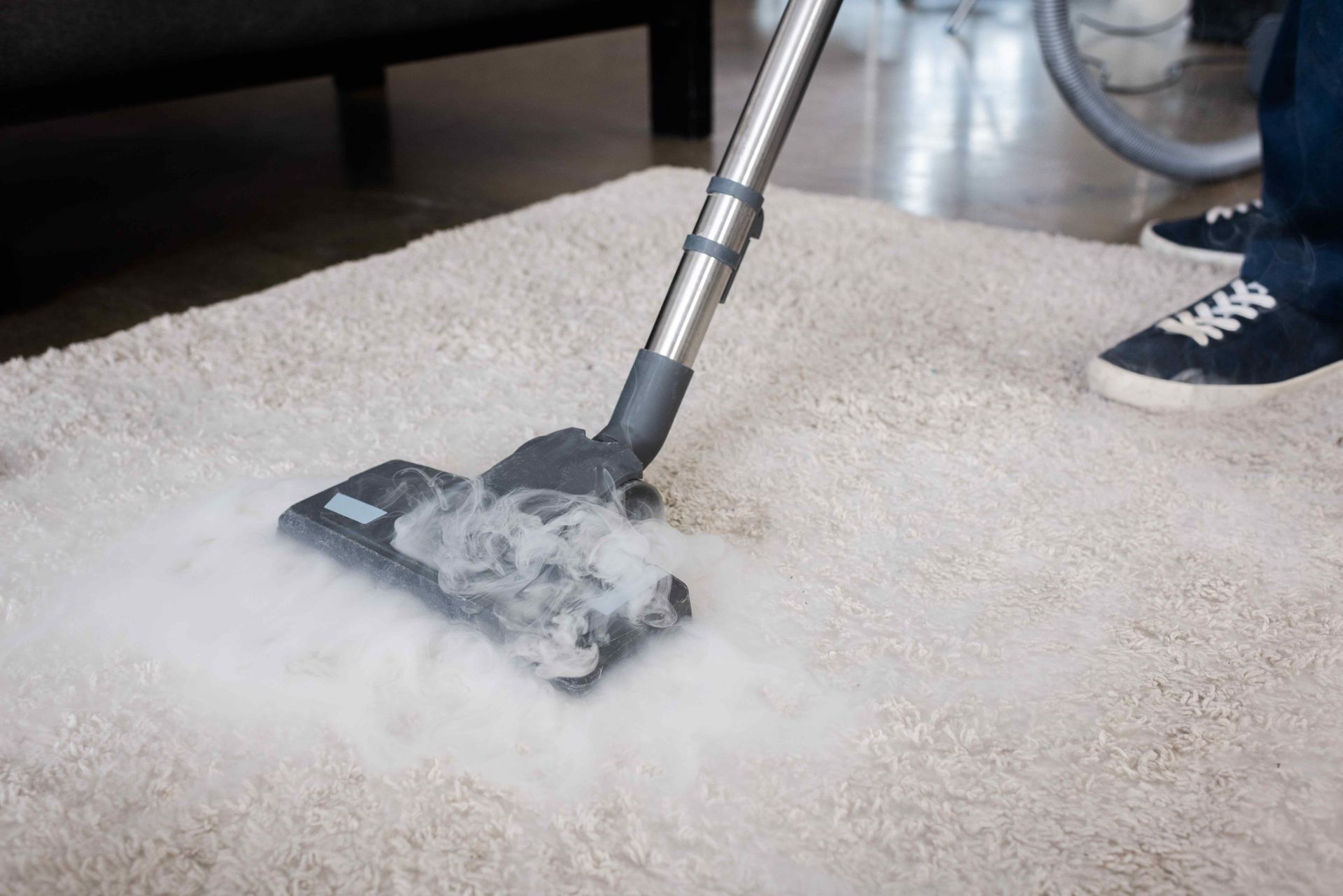 Steam cleaning a white rug