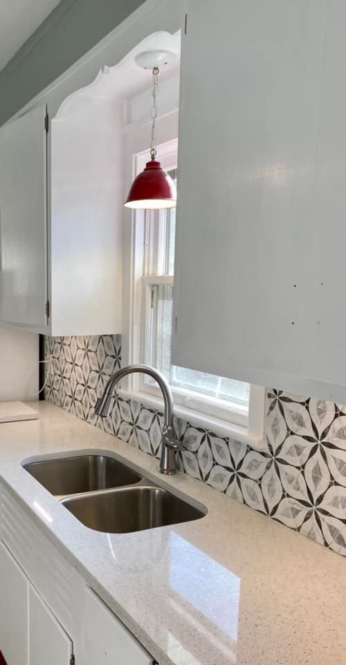 Kitchen backsplash and sink installation with modern fixtures