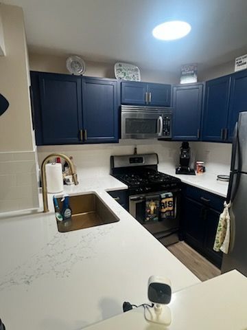 Kitchen remodeling with updated cabinets, sink, and countertops